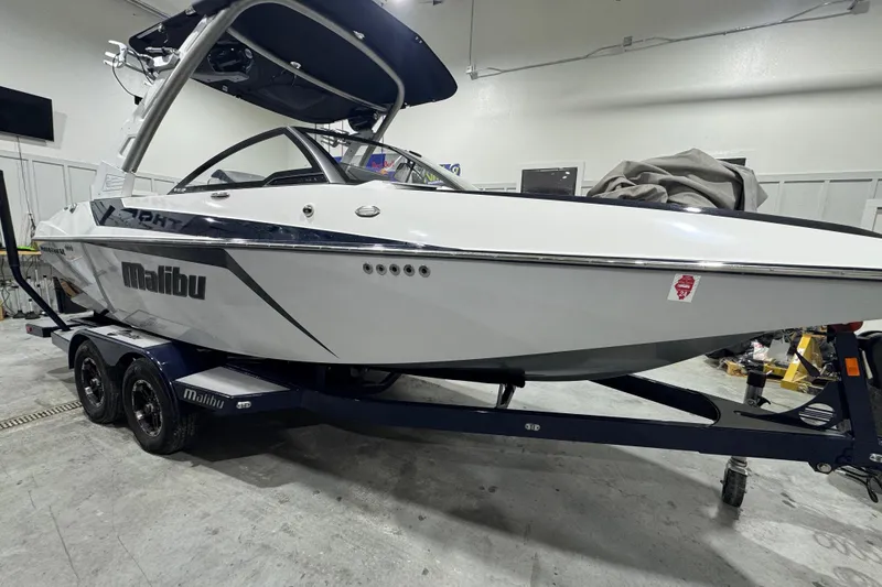 Slide: The Image of 2019 Malibu Wakesetter 21 MLX boat on trailer in indoor storage. - 6