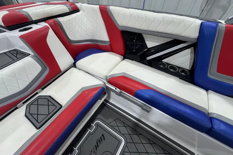 Slide: The Image of 2021 Tigé 25ZX boat interior with modern dashboard and red-white seating. - 24