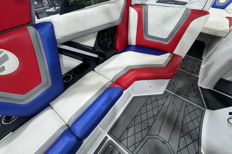 Slide: The Image of 2021 Tigé 25ZX boat interior with red, white, and blue seating and stylish design. - 26