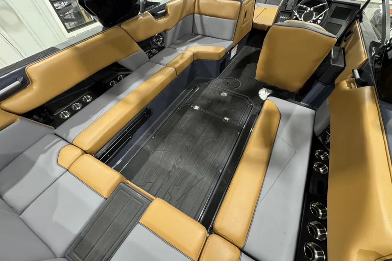 Slide: The Image of 2026 Moomba Tykon boat interior with tan and gray seating, modern design. - 10