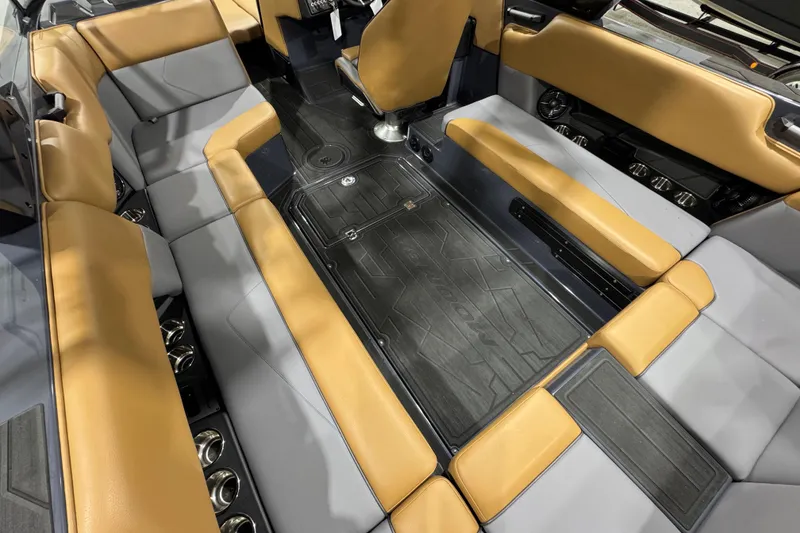 Slide: The Image of 2026 Moomba Tykon interior with tan and gray seating, showcasing modern design and spacious layout. - 11