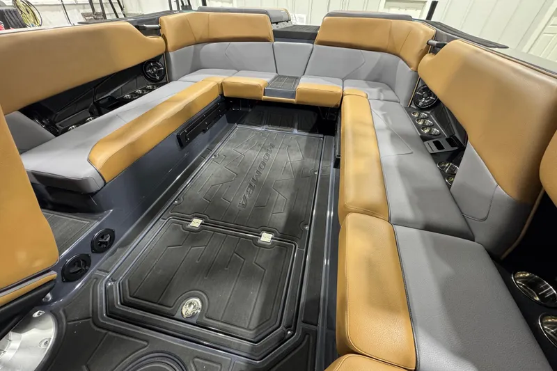 Slide: The Image of 2026 Moomba Tykon boat interior with tan and gray seating, spacious layout. - 12