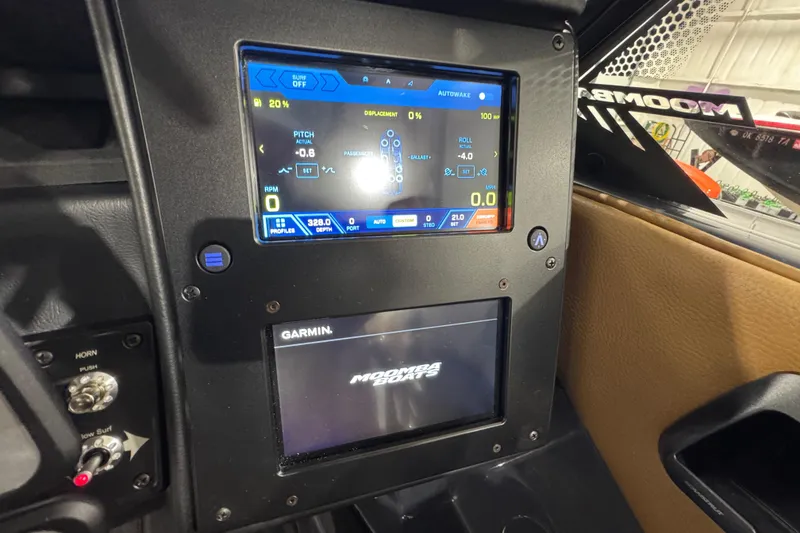 Slide: The Image of 2026 Moomba Tykon dashboard with digital display and Garmin navigation system. - 14