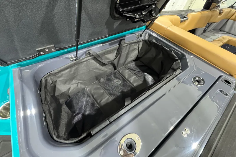 Slide: The Image of 2026 Moomba Tykon boat storage compartment with open lid and interior view. - 9