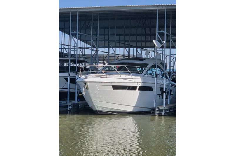 The Image of 2018 Cruisers Yachts 54 Cantius docked in a covered marina. - 1