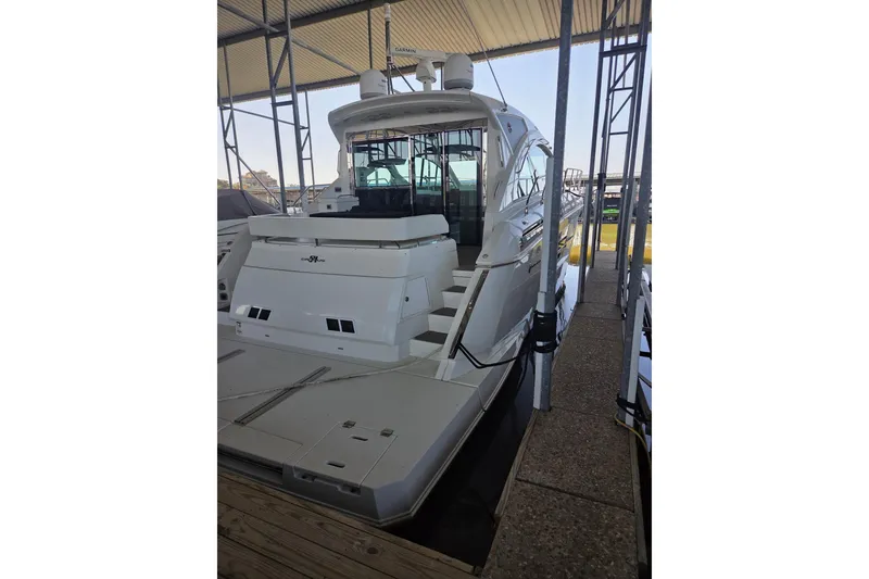 Slide: The Image of 2018 Cruisers Yachts 54 Cantius docked under a covered marina. - 21
