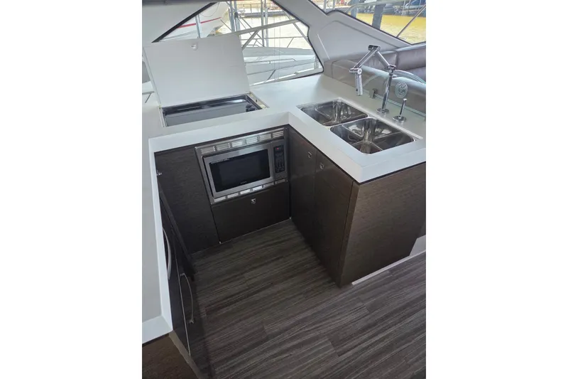Slide: The Image of 2018 Cruisers Yachts 54 Cantius kitchen with modern appliances and dual sinks. - 29