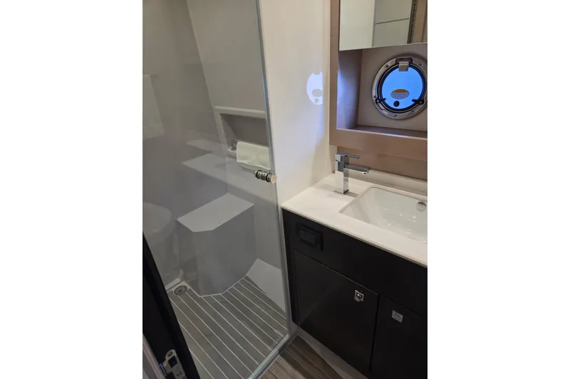 Slide: The Image of Luxurious bathroom in 2018 Cruisers Yachts 54 Cantius with modern fixtures and porthole window. - 19