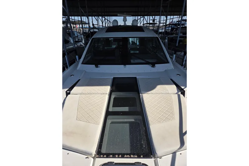Slide: The Image of 2018 Cruisers Yachts 54 Cantius, docked, showcasing sleek design and spacious deck. - 20