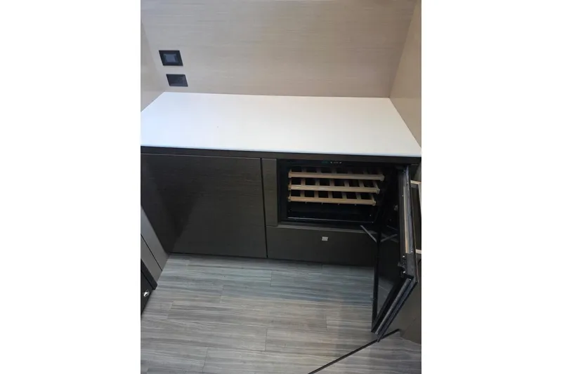 Slide: The Image of 2018 Cruisers Yachts 54 Cantius interior with open wine cooler and modern cabinetry. - 22