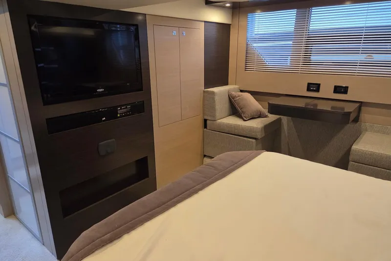 Slide: The Image of Luxurious interior of 2018 Cruisers Yachts 54 Cantius with TV, seating, and window blinds. - 23