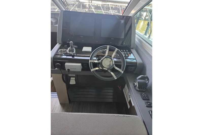 Slide: The Image of 2018 Cruisers Yachts 54 Cantius helm with modern controls and navigation screens. - 34