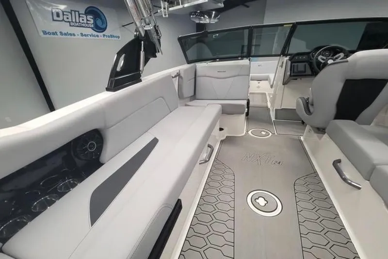 Slide: The Image of 2022 MasterCraft NXT24 boat interior with sleek seating and modern dashboard. - 9