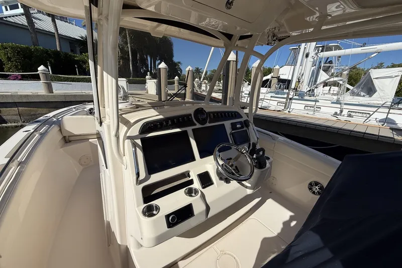 Slide: The Image of 2020 Grady-White Canyon 326 boat cockpit with steering wheel and control panel. - 10