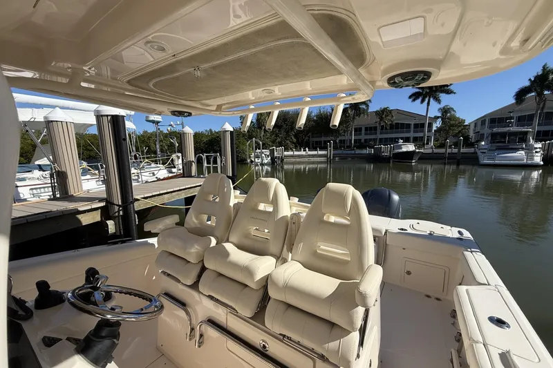Slide: The Image of 2020 Grady-White Canyon 326 boat interior with helm seats at marina. - 11