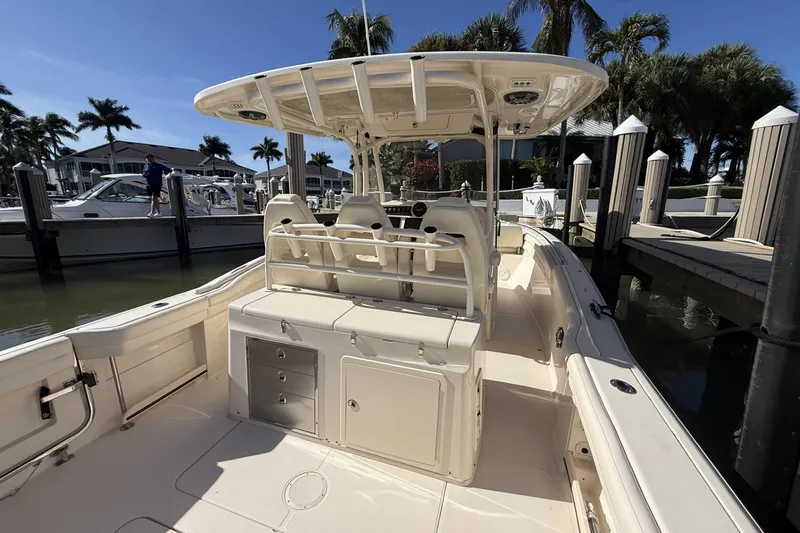 Slide: The Image of 2020 Grady-White Canyon 326 boat docked, featuring spacious seating and storage. - 14