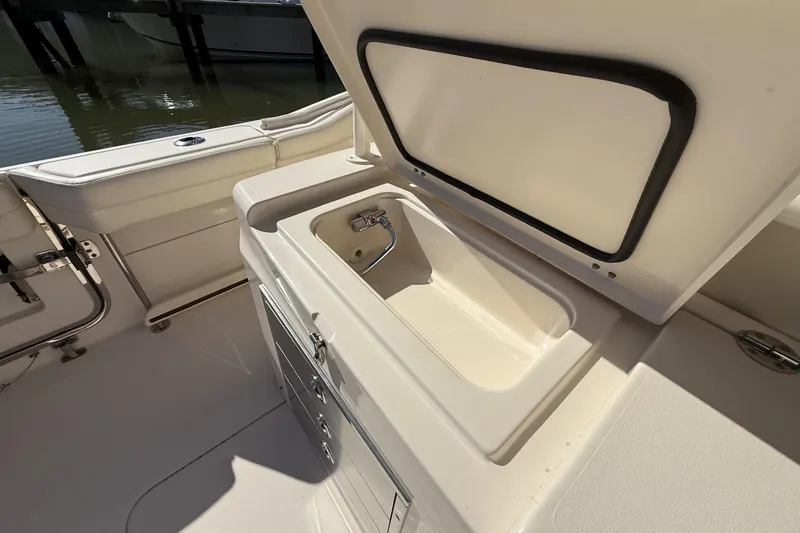 Slide: The Image of 2020 Grady-White Canyon 326 boat interior with open storage compartment. - 16