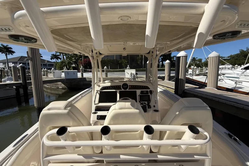 Slide: The Image of 2020 Grady-White Canyon 326 boat interior at marina, featuring helm and seating. - 17