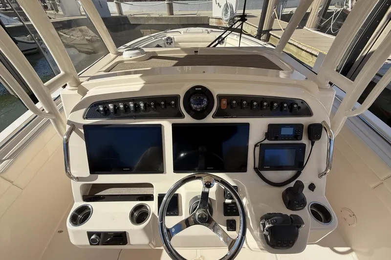 Slide: The Image of 2020 Grady-White Canyon 326 helm with dual screens and navigation controls. - 19