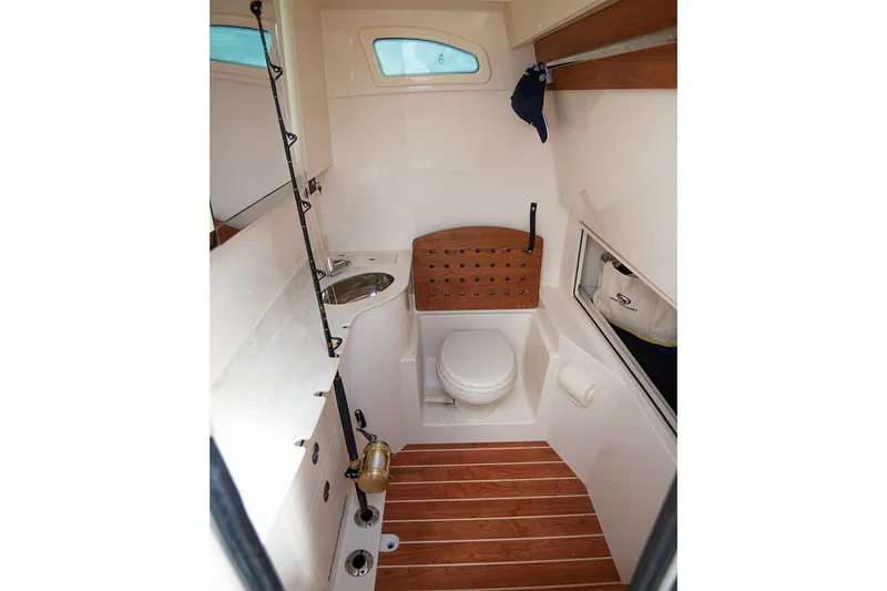 Slide: The Image of Manufacturer Provided Image: 2020 Grady-White Canyon 326 boat interior bathroom with wooden flooring and compact design. - 21