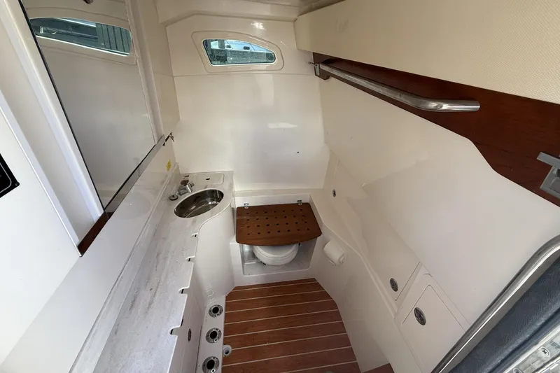 Slide: The Image of 2020 Grady-White Canyon 326 boat interior with sink and wooden accents. - 22