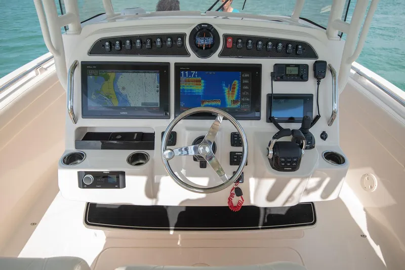 Slide: The Image of Manufacturer Provided Image: 2020 Grady-White Canyon 326 boat dashboard with navigation and control systems. - 24