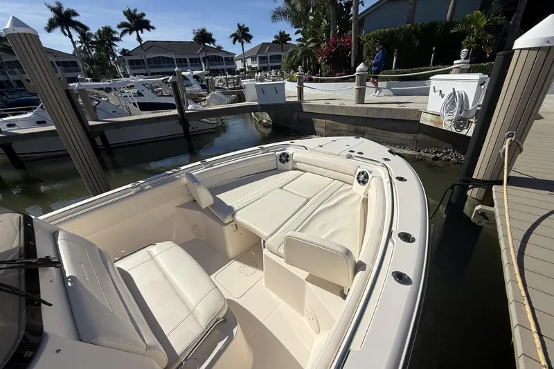 Slide: The Image of 2020 Grady-White Canyon 326 boat docked at marina with luxurious seating. - 5