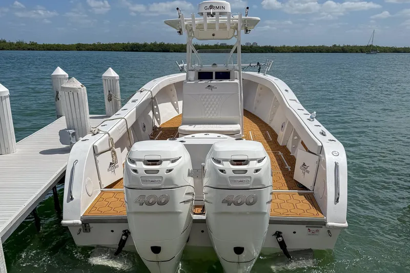 The Image of 2024 Ocean Runner 34 Center Console boat docked, featuring twin 400 horsepower engines. - 0
