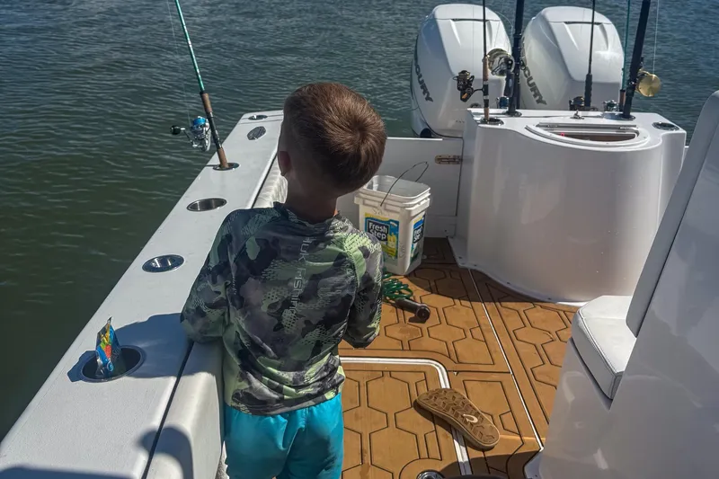 Slide: The Image of Young boy fishing on 2024 Ocean Runner 34 Center Console boat. - 12
