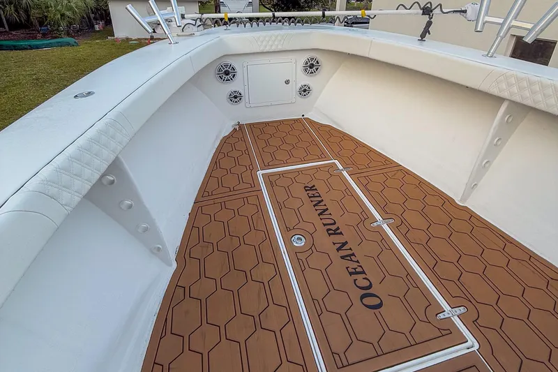 Slide: The Image of 2024 Ocean Runner 34 Center Console boat with teak-style flooring and white interior. - 5