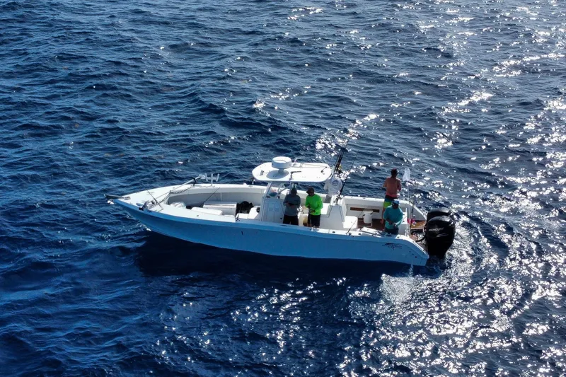 Slide: The Image of 2024 Ocean Runner 34 Center Console boat on open sea with people onboard. - 7
