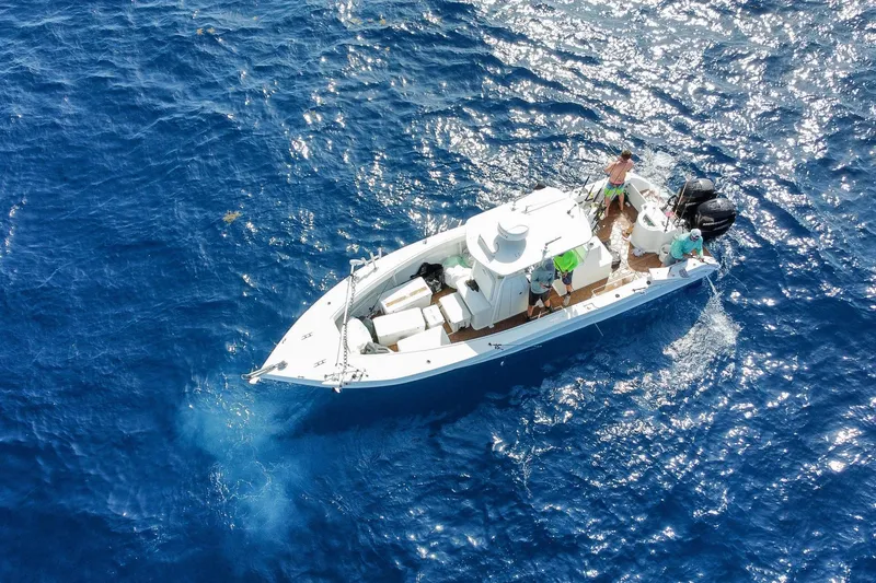 Slide: The Image of 2024 Ocean Runner 34 Center Console boat cruising on clear blue ocean waters. - 8