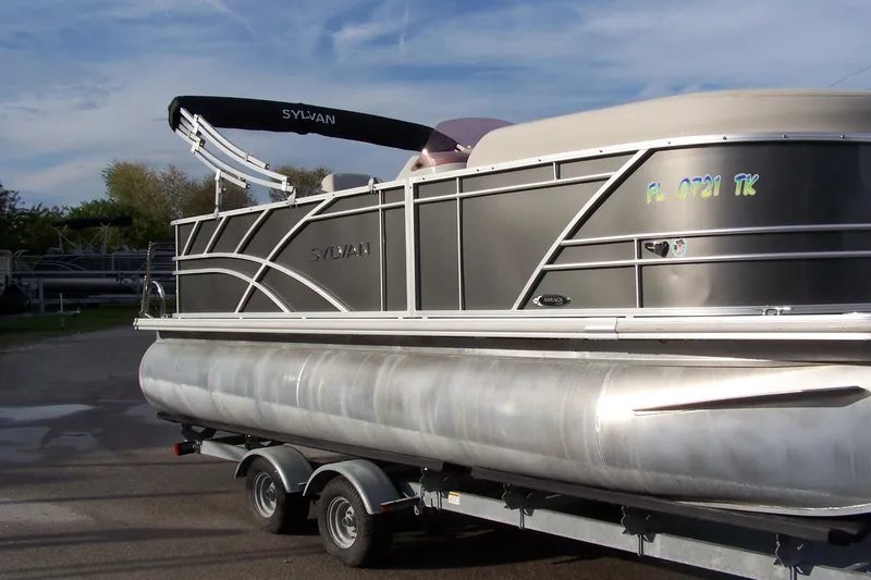 Slide: The Image of 2023 Sylvan Mirage 8520 Party Fish pontoon boat on trailer, side view. - 1