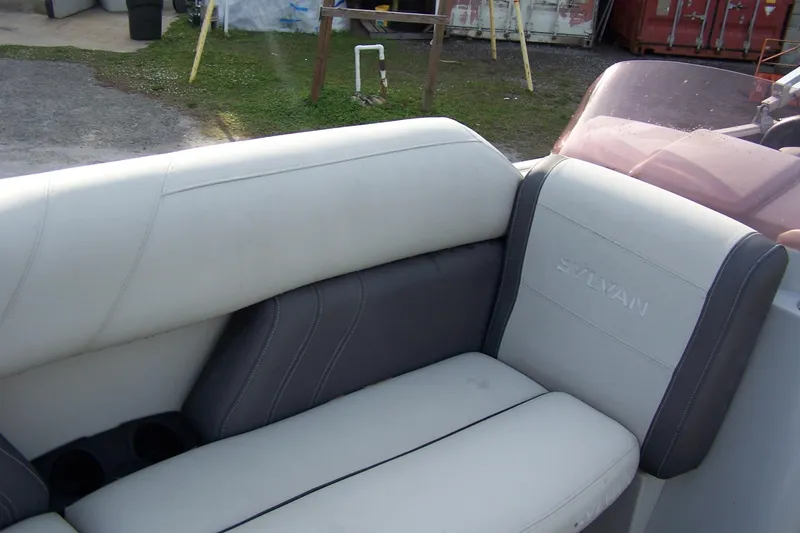 Slide: The Image of 2023 Sylvan Mirage 8520 Party Fish boat seating with white and gray upholstery. - 11