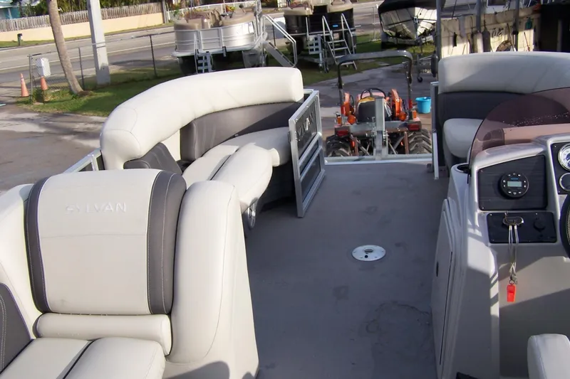 Slide: The Image of 2023 Sylvan Mirage 8520 Party Fish pontoon boat interior with plush seating and control panel. - 7