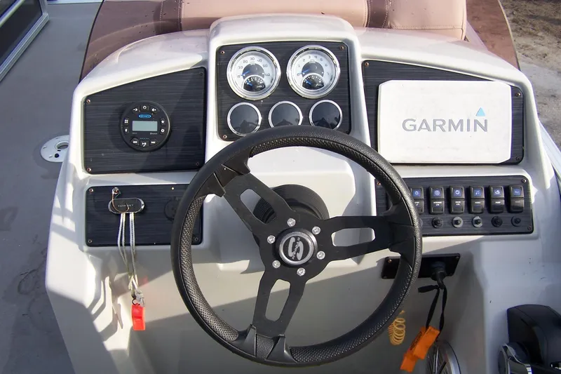 Slide: The Image of 2023 Sylvan Mirage 8520 Party Fish dashboard with steering wheel and Garmin navigation system. - 9