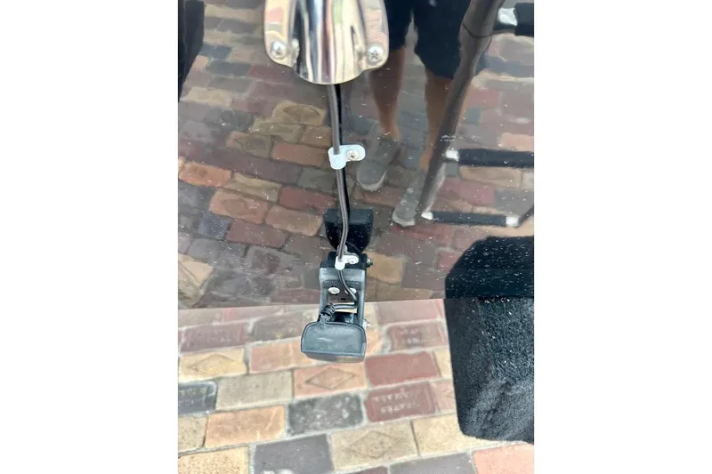 Slide: The Image of 2023 Starcraft SVX 171 OB boat detail with reflective surface and brick background. - 23