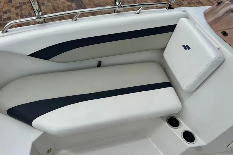 Slide: The Image of 2023 Starcraft SVX 171 OB boat interior with white and navy seating, cup holders. - 30