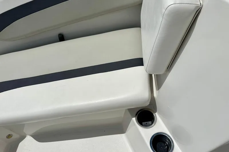 Slide: The Image of 2023 Starcraft SVX 171 OB boat seat with cup holders, featuring white and black upholstery. - 39