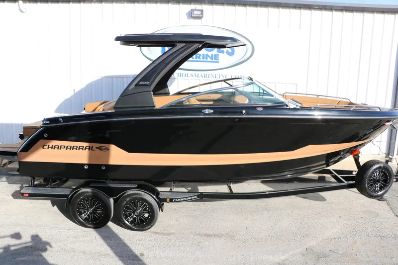 Slide: The Image of 2025 Chaparral 2870 SSX boat on trailer, black and tan design, side view. - 16