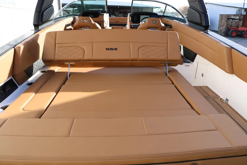 Slide: The Image of 2025 Chaparral 2870 SSX boat interior with tan leather seating and SSX logo. - 17