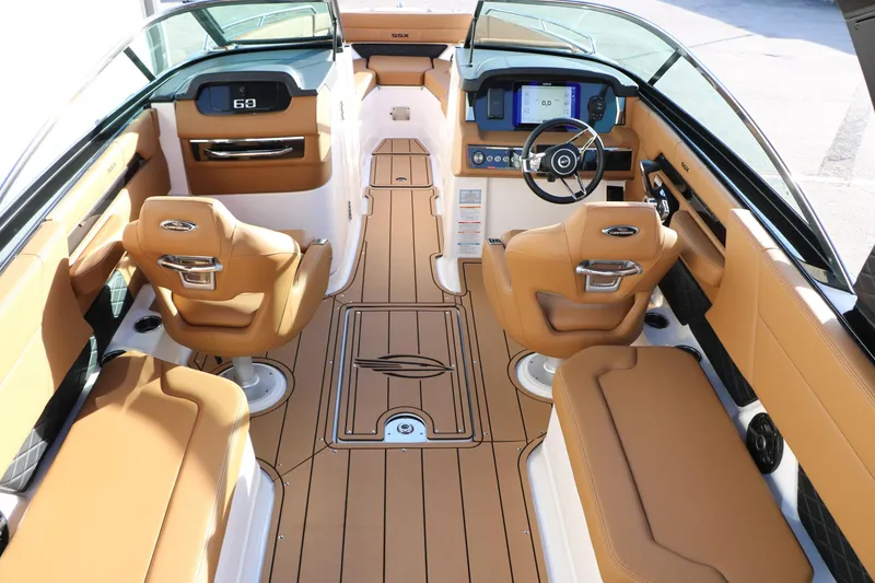 Slide: The Image of Luxurious interior of 2025 Chaparral 2870 SSX boat with tan seating and modern dashboard. - 18