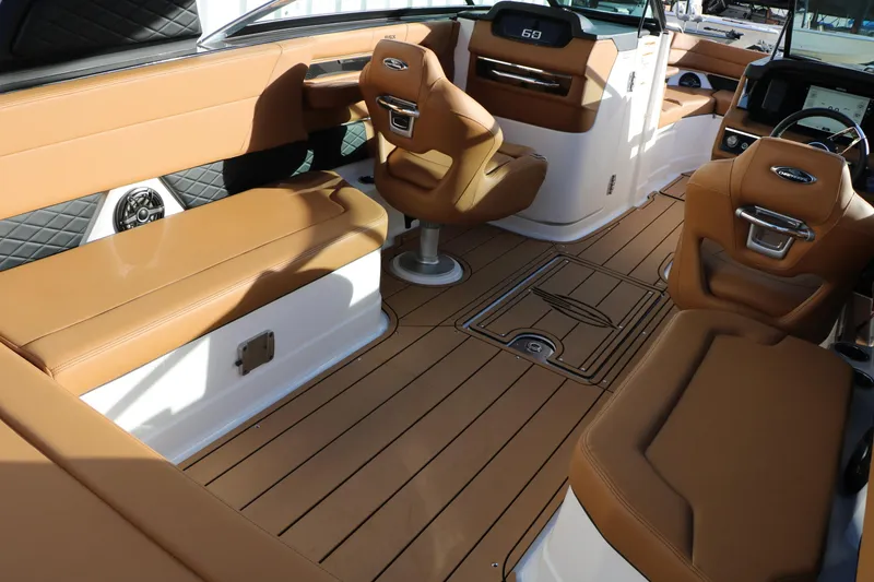 Slide: The Image of 2025 Chaparral 2870 SSX boat interior with tan leather seating and modern dashboard. - 20