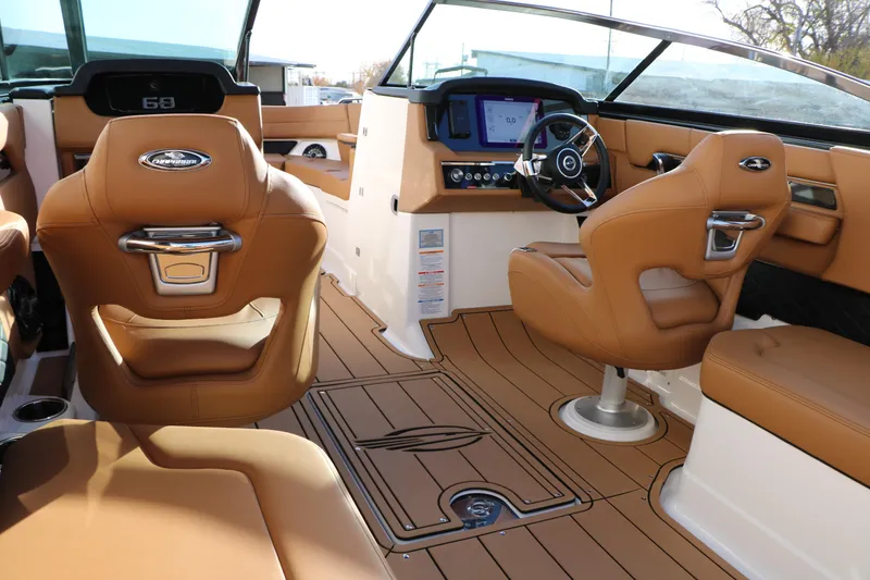 Slide: The Image of Luxurious interior of 2025 Chaparral 2870 SSX boat with tan leather seating and modern dashboard. - 21