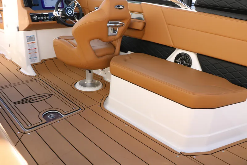 Slide: The Image of 2025 Chaparral 2870 SSX boat interior with tan seating and modern dashboard. - 24