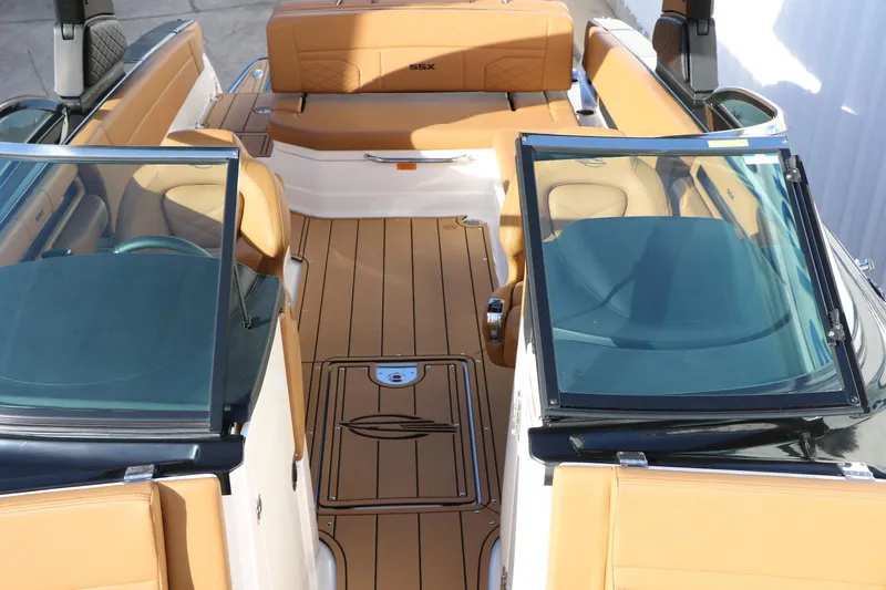 Slide: The Image of 2025 Chaparral 2870 SSX boat interior with tan seating and sleek design. - 28