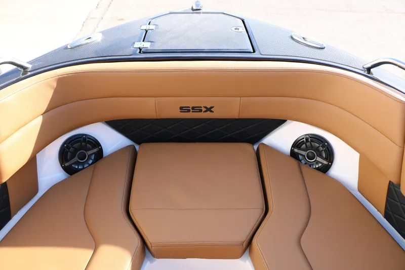 Slide: The Image of 2025 Chaparral 2870 SSX boat interior with tan seating and speakers. - 30