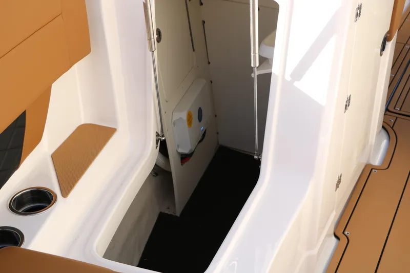 Slide: The Image of 2025 Chaparral 2870 SSX boat interior with open storage compartment. - 32