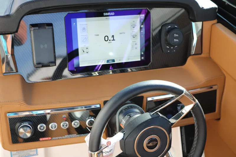Slide: The Image of Dashboard of 2025 Chaparral 2870 SSX boat with steering wheel and digital display. - 35