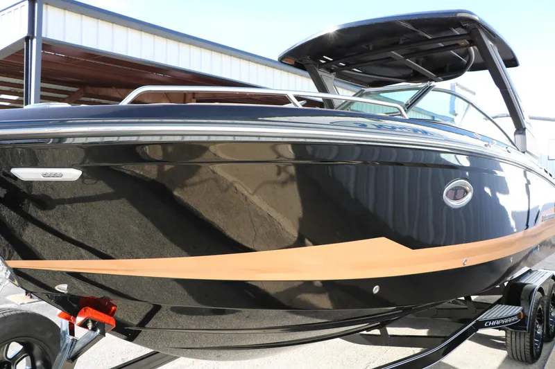 Slide: The Image of 2025 Chaparral 2870 SSX boat with sleek black and tan design. - 9